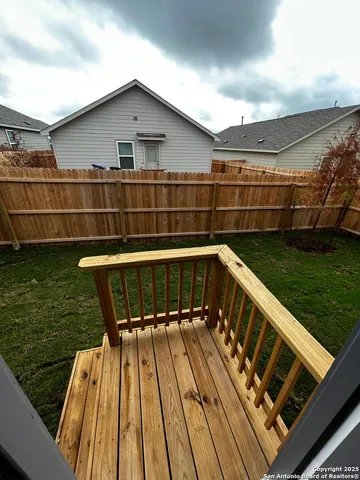 a view of a roof deck with wooden floor and fence