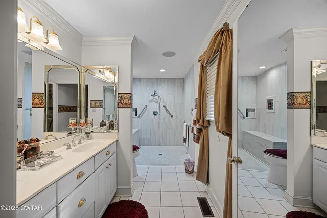 a spacious bathroom with a sink a toilet and shower