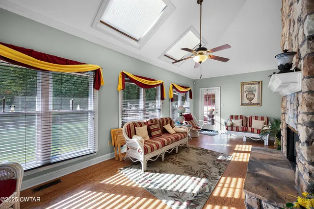 a living room with furniture a fireplace and a window