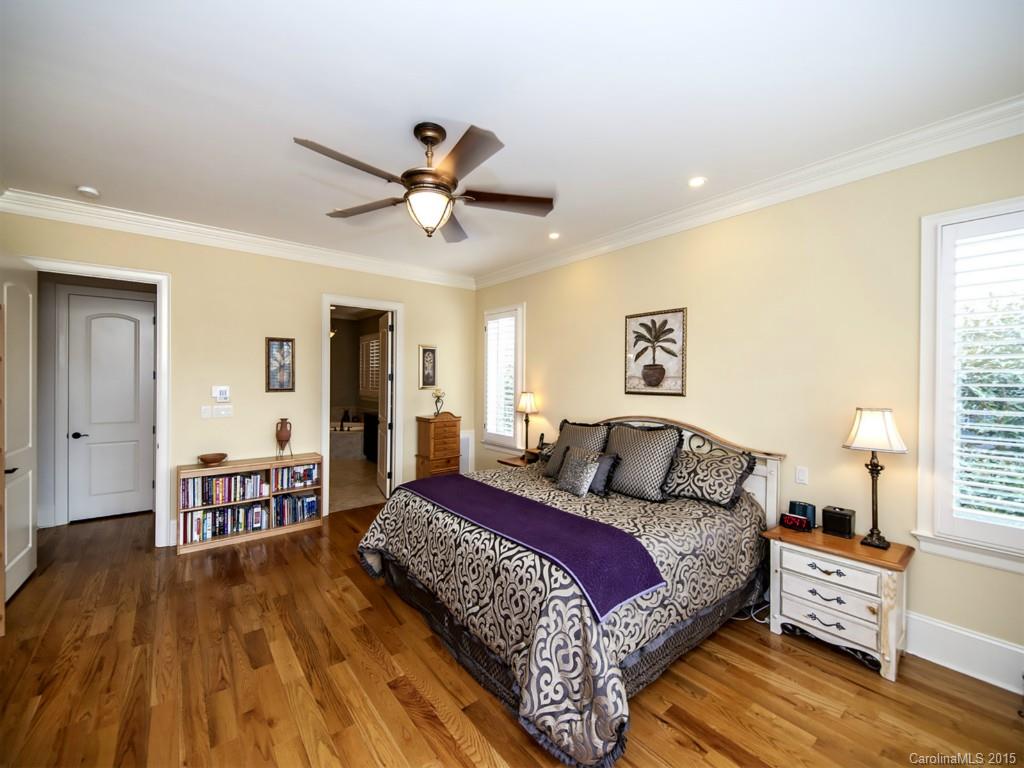 262 Horton Grove Road Fort Mill, SC 29715 - Photo 13 of 24 a bedroom with a large bed and a chandelier