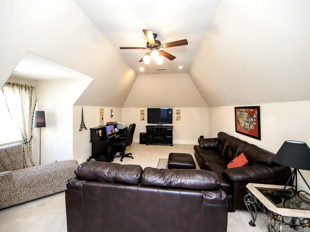 262 Horton Grove Road Fort Mill, SC 29715 - Photo 22 of 24 a living room with furniture and a chandelier