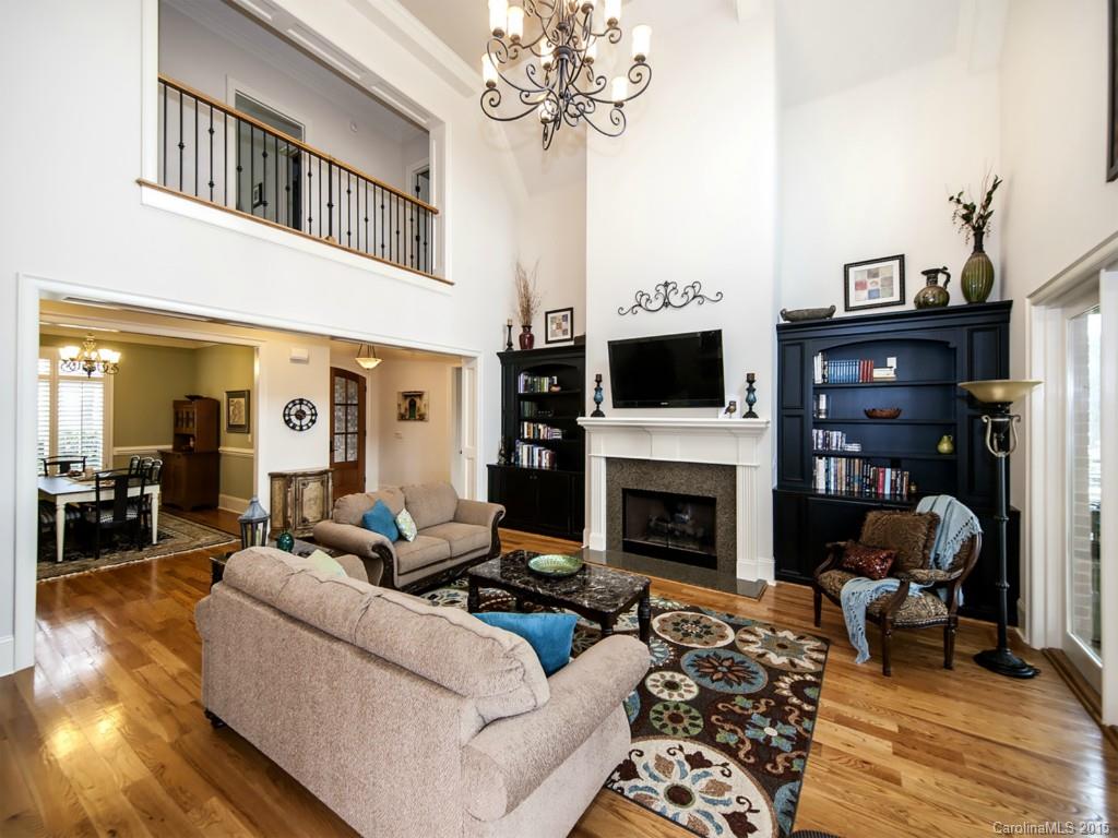 262 Horton Grove Road Fort Mill, SC 29715 - Photo 6 of 24 a living room with furniture a fireplace and a chandelier