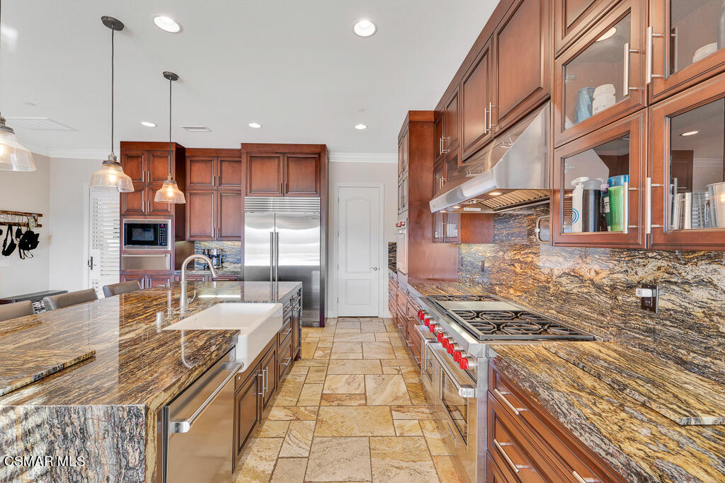 7379 Nicklaus Road Moorpark, CA 93021 - Photo 15 of 85 a kitchen with stainless steel appliances granite countertop a stove and a sink