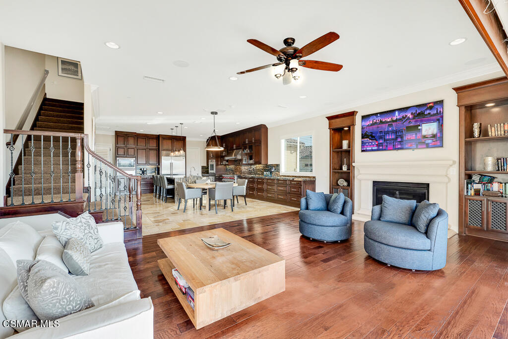 7379 Nicklaus Road Moorpark, CA 93021 - Photo 24 of 85 a living room with furniture a fireplace and a flat screen tv