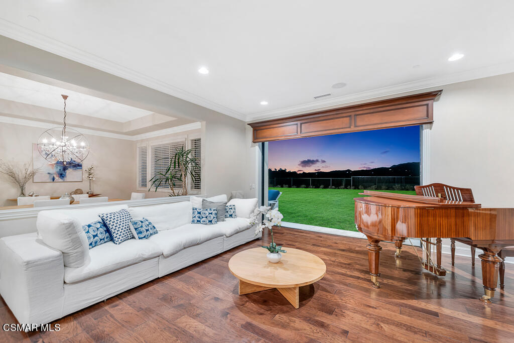 7379 Nicklaus Road Moorpark, CA 93021 - Photo 26 of 85 a living room with furniture a floor to ceiling window and a outdoor kitchen