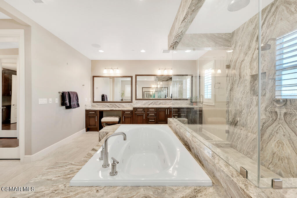 7379 Nicklaus Road Moorpark, CA 93021 - Photo 48 of 85 a bathroom with a tub sink and mirror