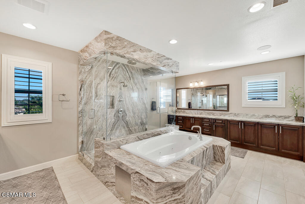 7379 Nicklaus Road Moorpark, CA 93021 - Photo 52 of 85 a spacious bathroom with a double vanity sink and a mirror