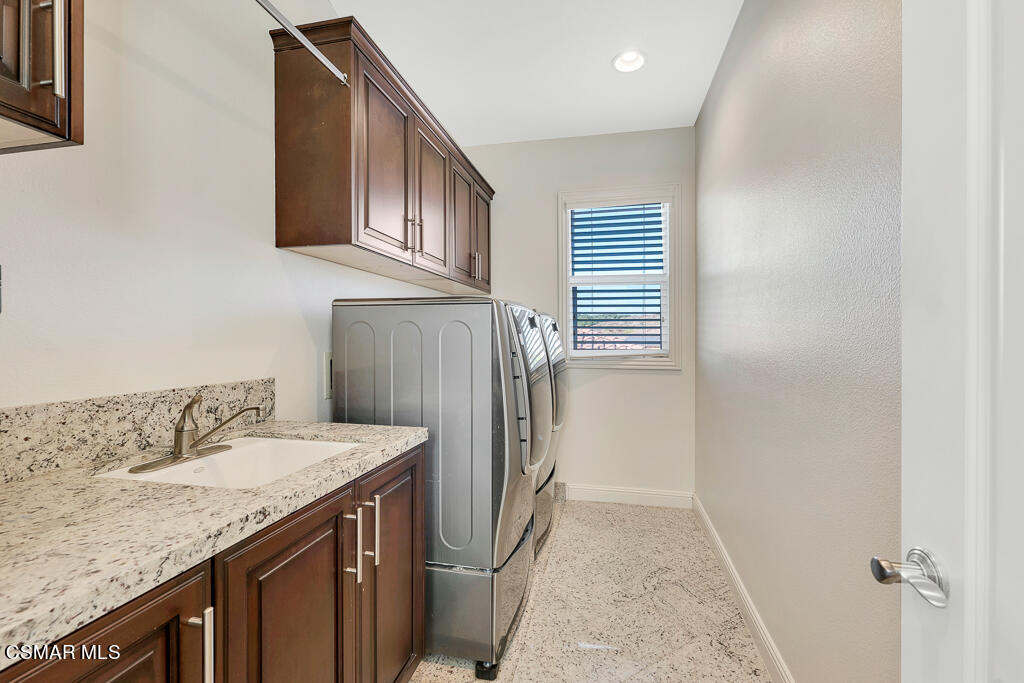 7379 Nicklaus Road Moorpark, CA 93021 - Photo 54 of 85 a bathroom with a granite countertop sink and a mirror