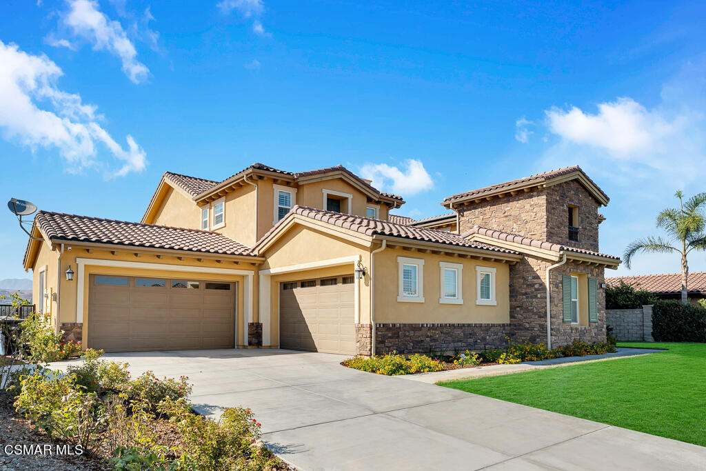 7379 Nicklaus Road Moorpark, CA 93021 - Photo 82 of 85 a front view of a house with a yard and garage