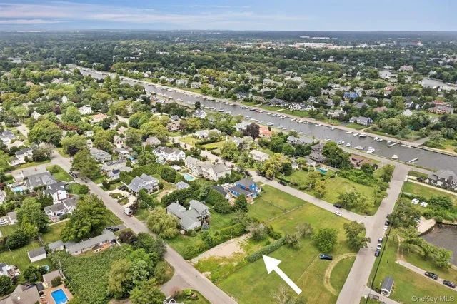 an aerial view of residential houses with outdoor space and trees
