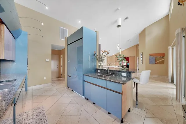 a large kitchen with stainless steel appliances granite countertop a stove and a microwave