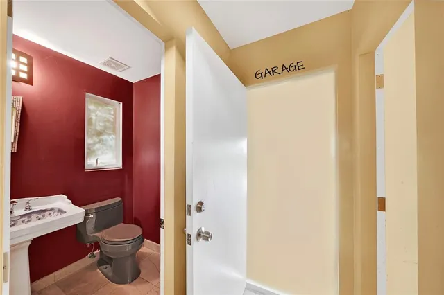 a white toilet sitting next to a white wall