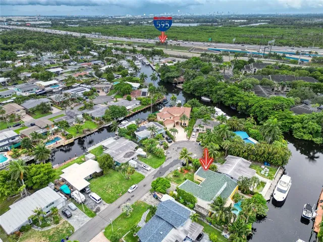 an aerial view of a house with a yard and outdoor seating