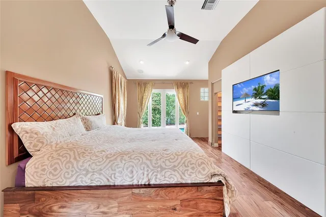 a large bed sitting in a bedroom next to a window