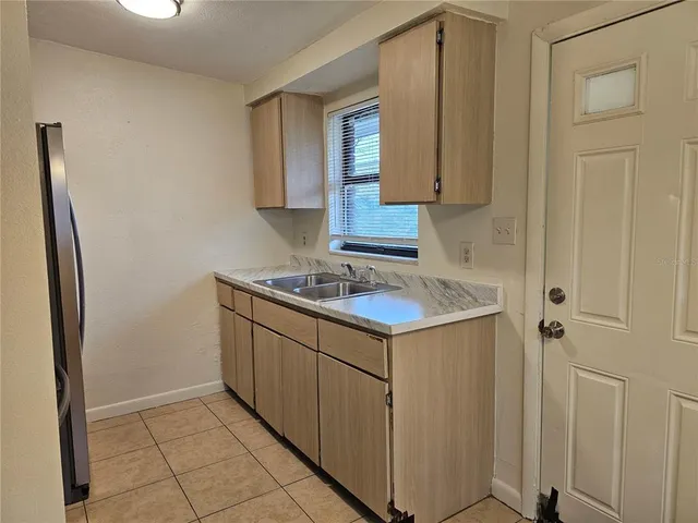 a kitchen with stainless steel appliances a refrigerator and cabinets