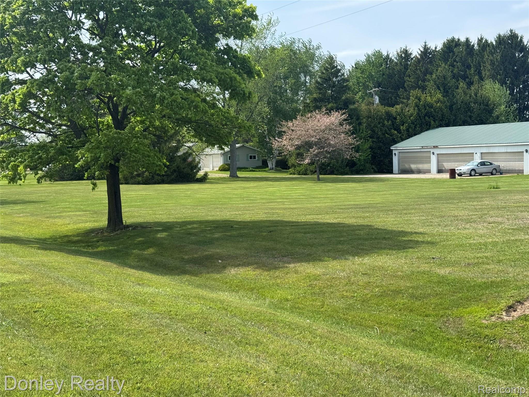2100 Sanilac Road Sandusky, MI 48471 - Photo 34 of 36 View of green lawn featuring a detached garage
