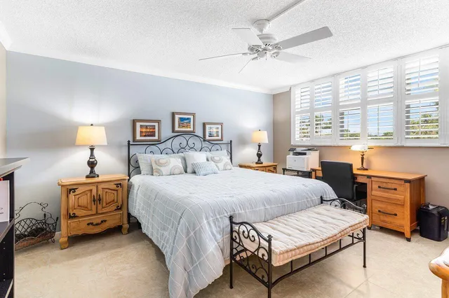 a spacious bedroom with a bed and a table