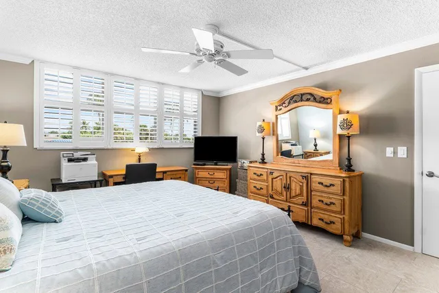 a bedroom with a large bed and a large window