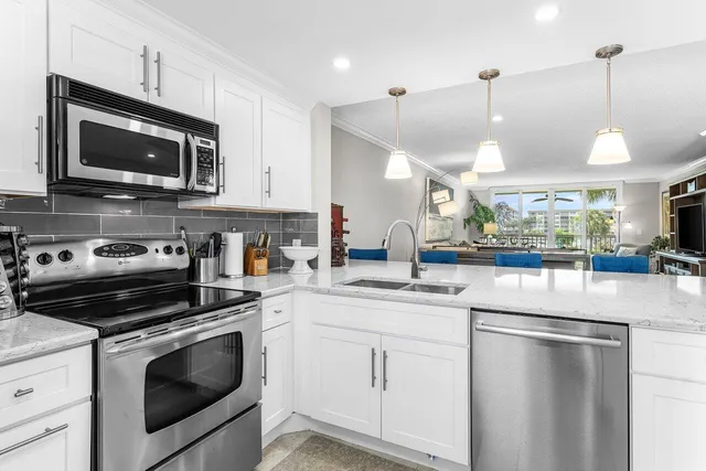 a kitchen with a sink and steel appliances