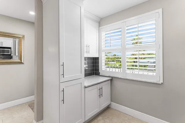 a view of a kitchen cabinets and a window