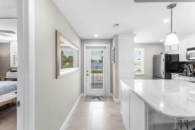 a view of a kitchen and dining area with chandelier