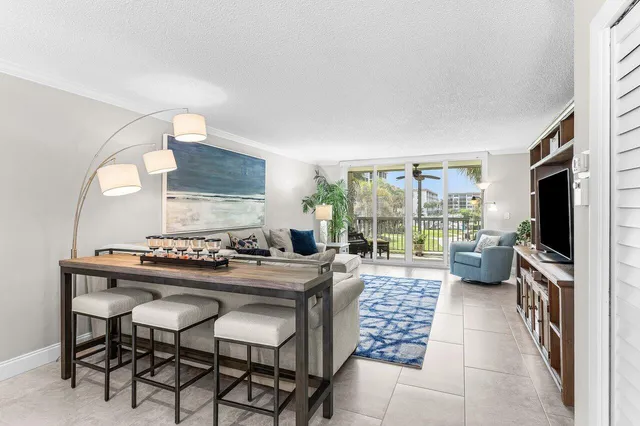 a kitchen with a table chairs stove and granite counter top