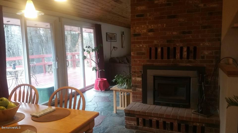 1785 East Windsor Road Windsor, MA 01270 - Photo 16 of 24 a living room with furniture a large window and a fireplace