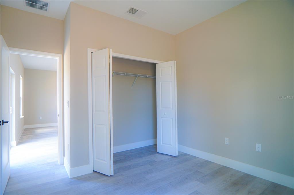 8413 Southwest 131st Lane Ocala, FL 34473 - Photo 16 of 28 an empty room with wooden door