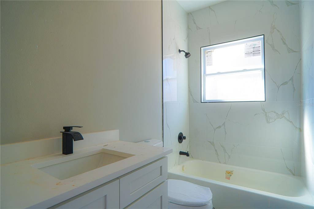 8413 Southwest 131st Lane Ocala, FL 34473 - Photo 21 of 28 a white bath tub sitting next to a white sink