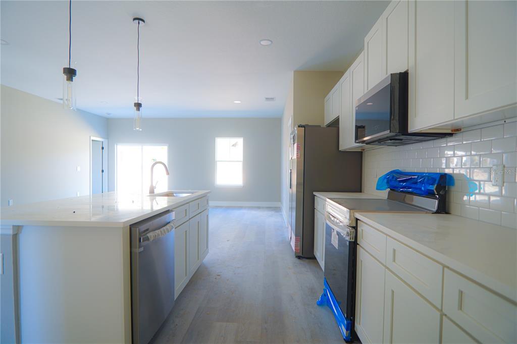 8413 Southwest 131st Lane Ocala, FL 34473 - Photo 7 of 28 a kitchen with stainless steel appliances granite countertop a sink a stove and a refrigerator