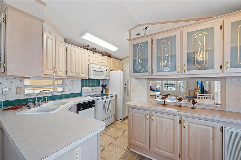 14 Basin Street Palmetto, FL 34221 - Photo 13 of 27 a kitchen with stainless steel appliances granite countertop a sink and cabinets with wooden floor