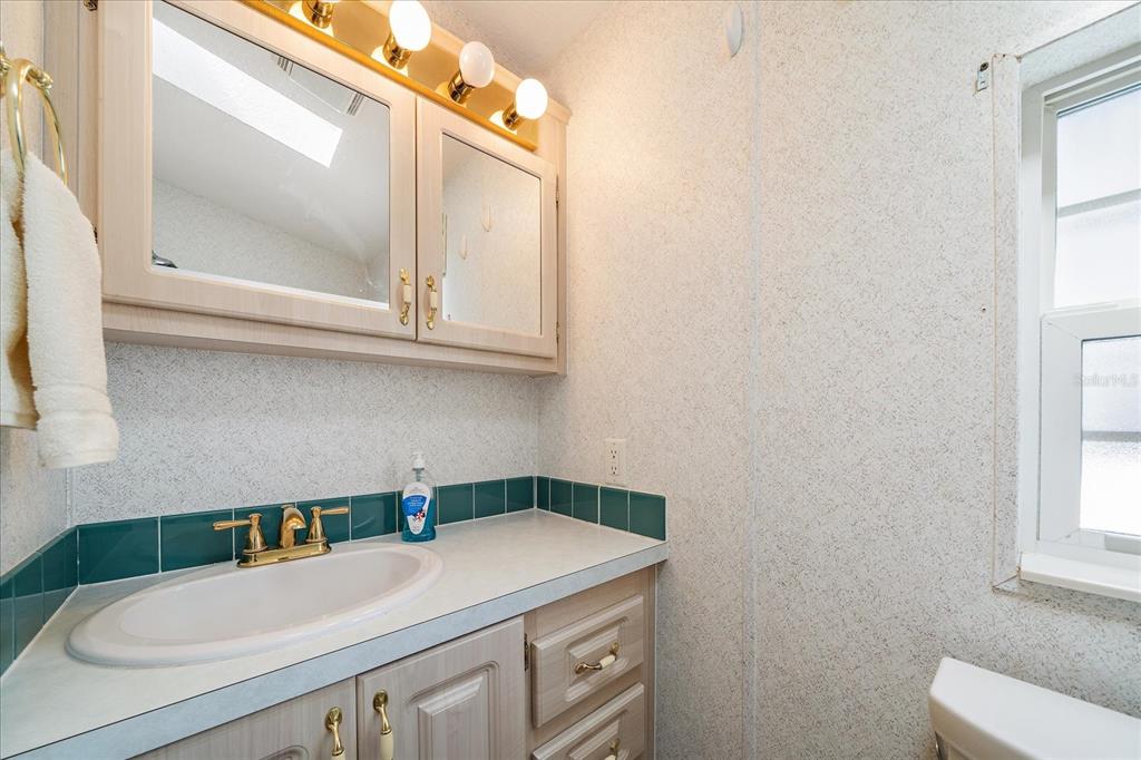 14 Basin Street Palmetto, FL 34221 - Photo 17 of 27 a bathroom with a sink a toilet and a mirror