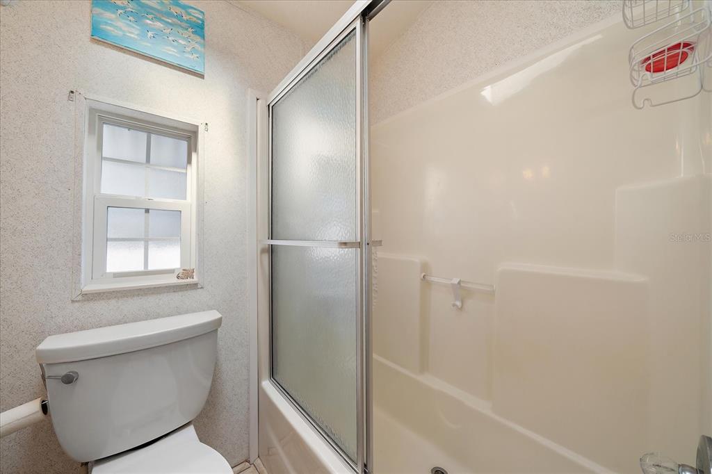 14 Basin Street Palmetto, FL 34221 - Photo 18 of 27 a bathroom with a toilet and a shower