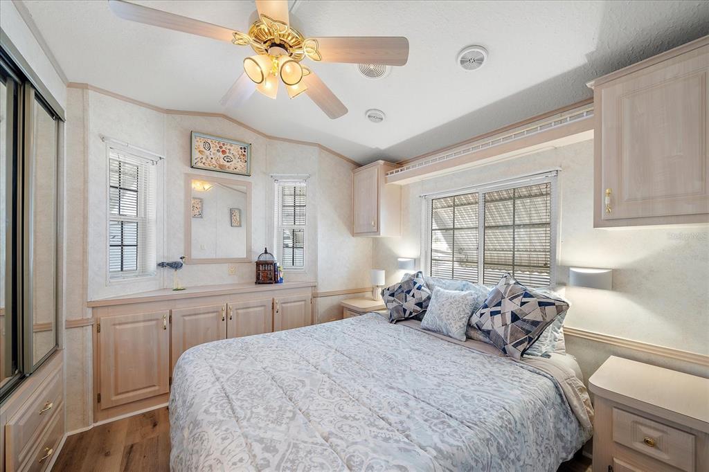 14 Basin Street Palmetto, FL 34221 - Photo 19 of 27 a bedroom with a bed and a chandelier