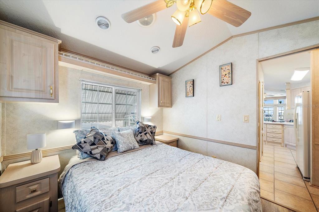 14 Basin Street Palmetto, FL 34221 - Photo 20 of 27 a bedroom with a bed and a chandelier