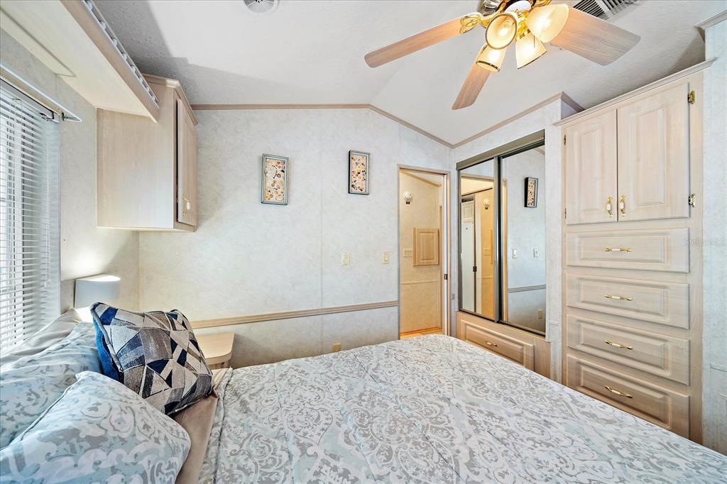 14 Basin Street Palmetto, FL 34221 - Photo 21 of 27 a bed room with a bed and a chandelier