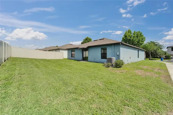 a view of a house with a backyard