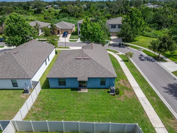 a aerial view of a house with swimming pool and a yard