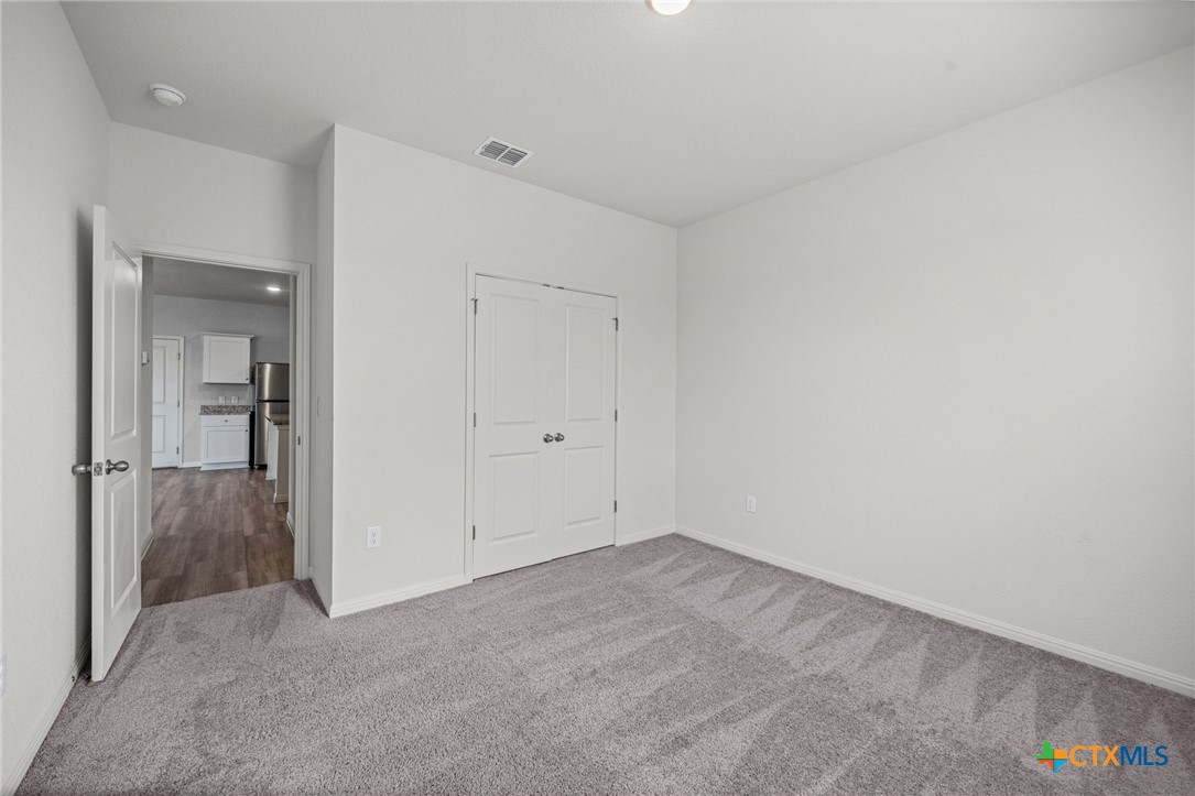 231 Enforcer Loop Jarrell, TX 76537 - Photo 16 of 41 Bedroom 1 downstairs (could be office, flex room, in law suite, etc.)