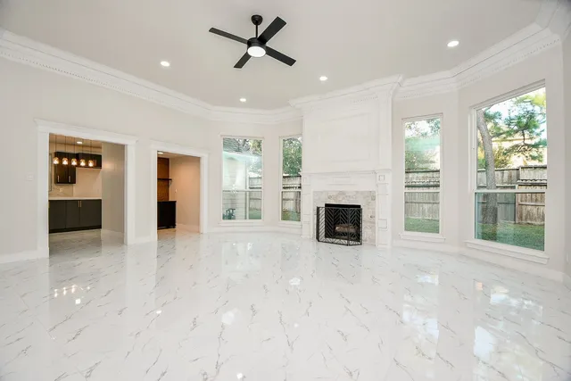 a view of an empty room with a fireplace and a window