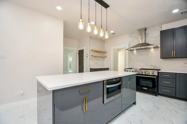 a kitchen with stainless steel appliances a sink and cabinets