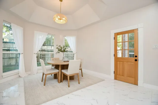 a dining room with furniture and window