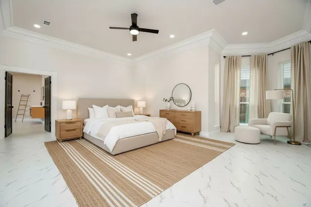 a bedroom with a large bed and a chandelier