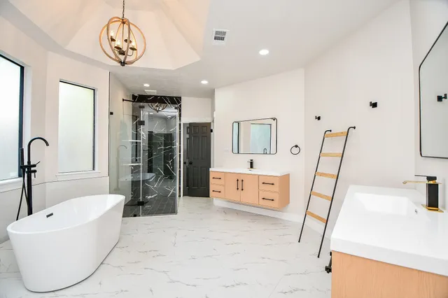 a bathroom with a tub sink and mirror