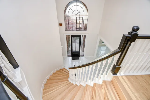 a view of staircase with wooden floor and a window