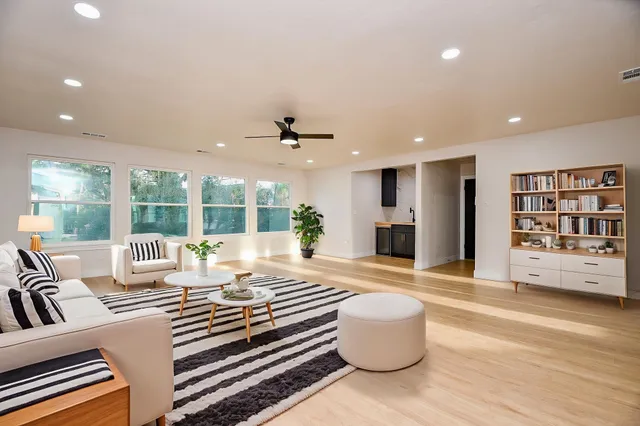 a living room with furniture and a large window