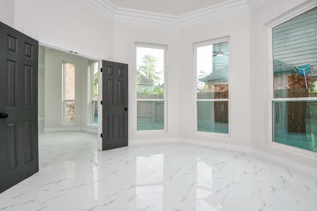 an empty room with windows and closet