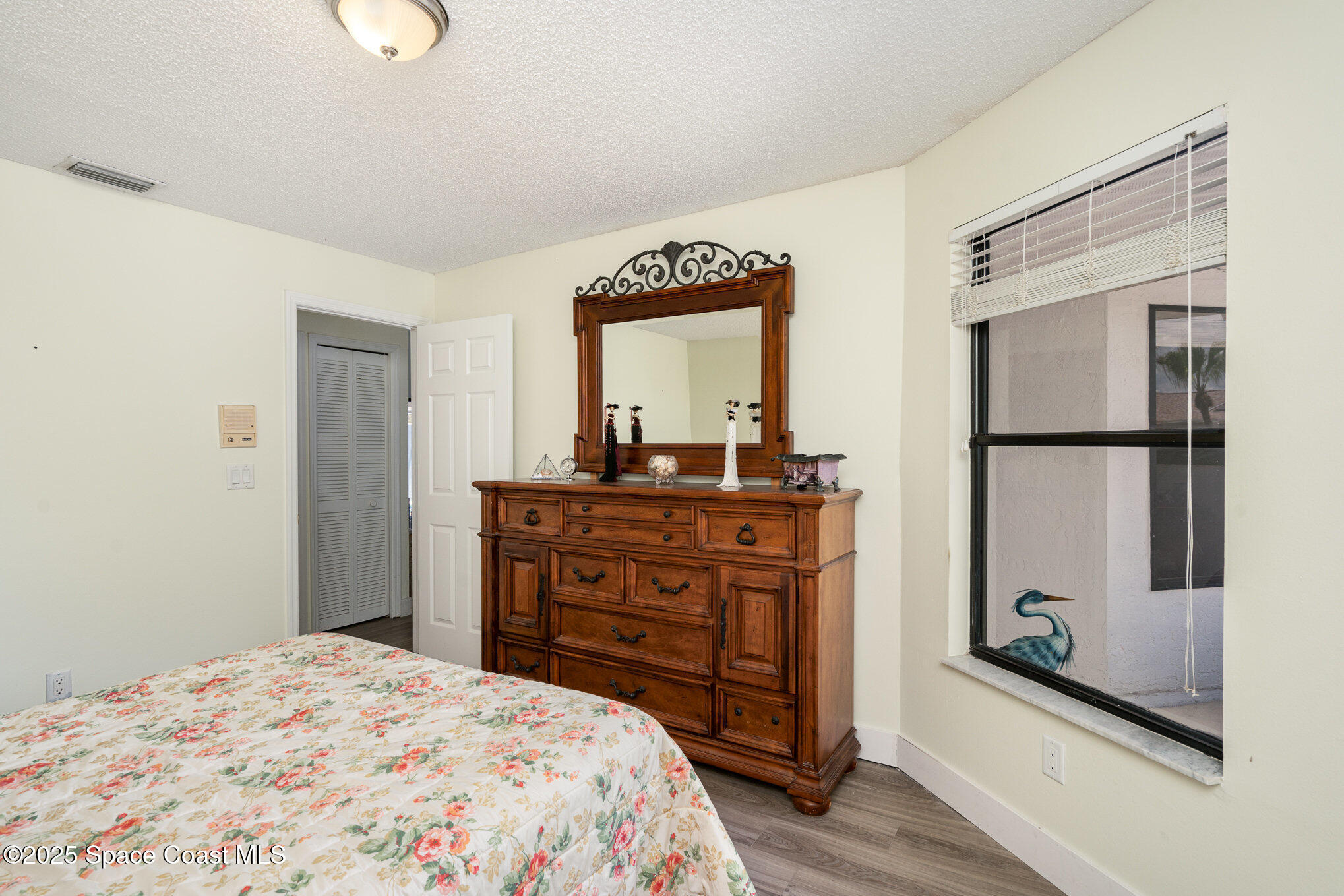 313 Pine Ridge Lane Melbourne, FL 32940 - Photo 15 of 28 a bedroom with a bed and a dresser