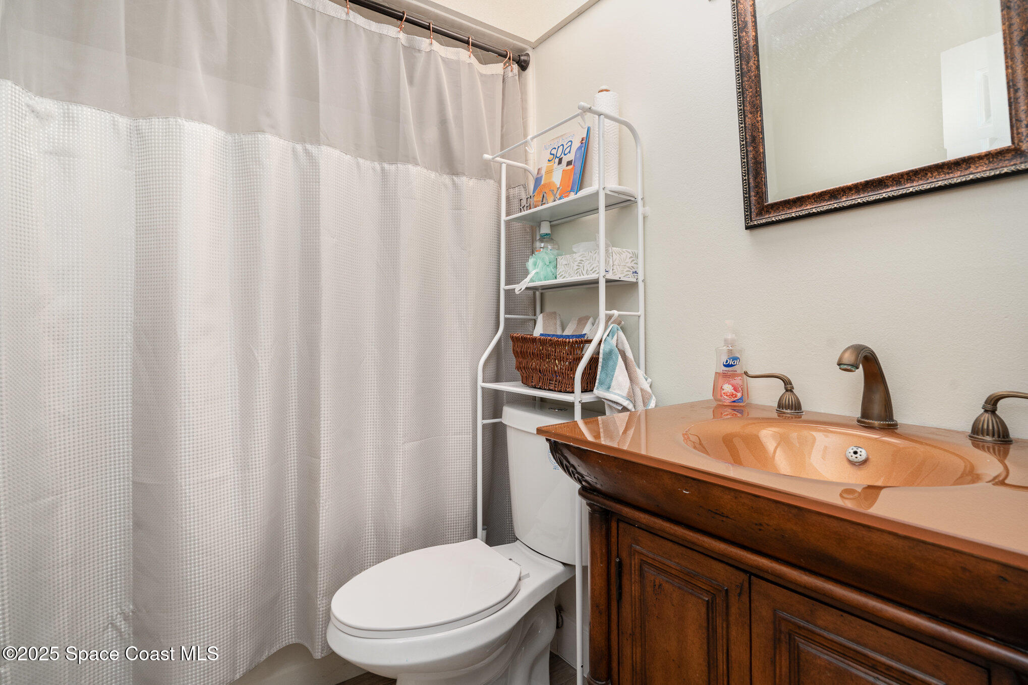 313 Pine Ridge Lane Melbourne, FL 32940 - Photo 17 of 28 a bathroom with a sink and a toilet