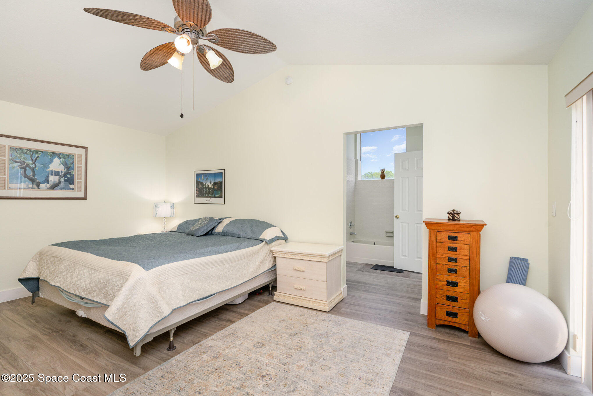 313 Pine Ridge Lane Melbourne, FL 32940 - Photo 18 of 28 a bedroom with a bed and wooden floor